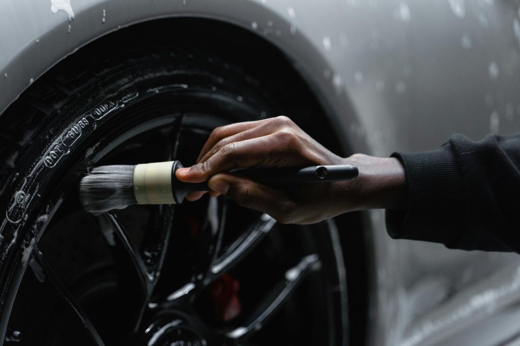 pexels-photo-6872175-6872175-1 A Person Cleaning Tire of a Car